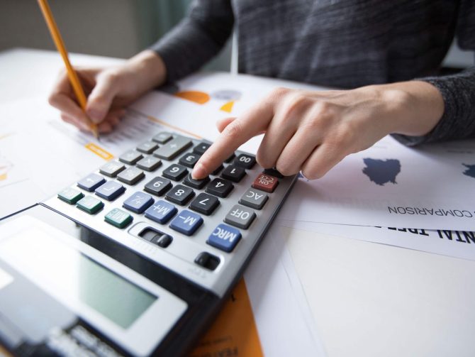 close-up-female-hand-counting-with-calculator