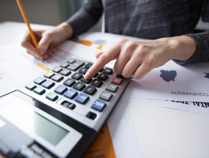 close-up-female-hand-counting-with-calculator